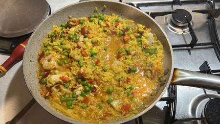 Valencian paella rice and fish in a pan while cooking. High quality photoの写真素材