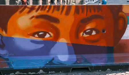Verona, Italy - 2019 08 26: overview of the traffic dividers painted with eyes of various colors and ethnic races. High quality photoのeditorial素材