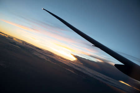 sunrise from the window with intercontinental airplane wing. High quality photo