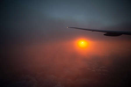 sunrise from the window with intercontinental airplane wing. High quality photo
