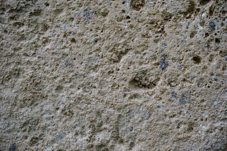 stone wall made of pipe stone worn by time. High quality photo