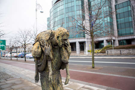 Dublin, Irelnad: 2016 04 03 The Famine Memorial Custom House staue monument in rainy day. High...