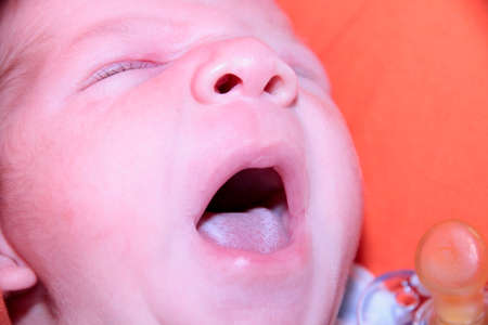 newborn baby yawns after sucking milk. High quality photo