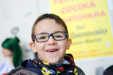 child with glasses laughs at the camera. High quality photoの写真素材