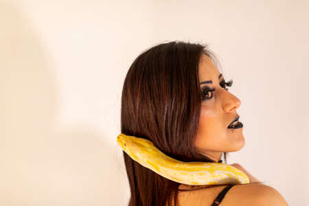 albino molur python with a dark goth brunette girl. High quality photoの写真素材