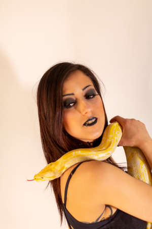 albino molur python with a dark goth brunette girl. High quality photo