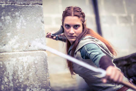 Lucca, Italy - 2018 10 31: elf woman warrior with bow and swords. High quality photoのeditorial素材