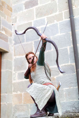 Lucca, Italy - 2018 10 31: elf woman warrior with bow and swords. High quality photoのeditorial素材