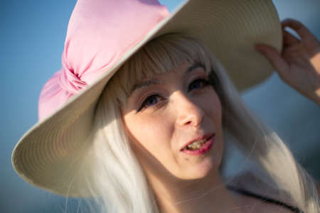 Rimini, Italy - 2016 07 21: Rimini Comics free cosplay event around beach and seaside pink hat bikini girl. High quality photoのeditorial素材