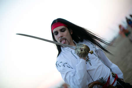 long-haired boy with vampire pirate costume and sword. High quality photoのeditorial素材