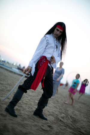 long-haired boy with vampire pirate costume and sword. High quality photoの写真素材