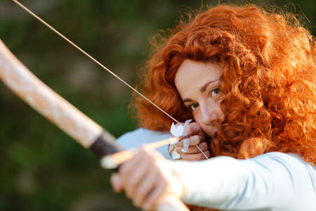 Lucca, Italy - 2018 10 31: Lucca Comics free cosplay event around city The Brave Merida with bow. High quality photo