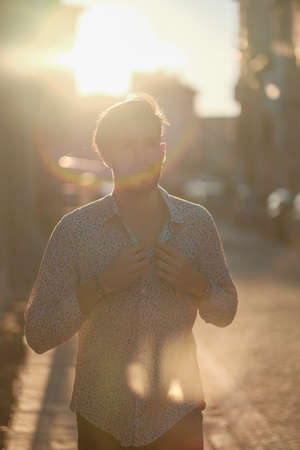 handsome Italian guy poses against the light at sunset. High quality photoの写真素材