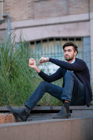 handsome Italian boy sitting on ancient staircase in Parma. High quality photoの写真素材