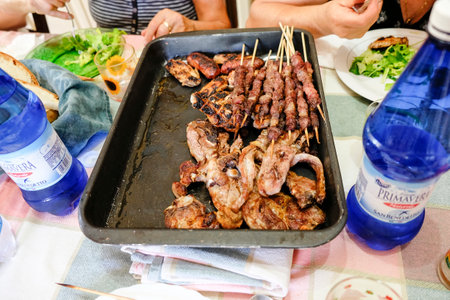 grilled meat cooked on the fire with sausages and chops and skewers. High quality photo