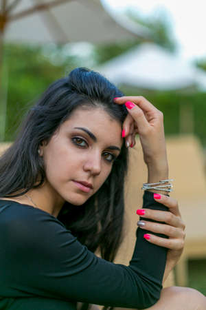 portrait of beautiful Italian brunette Mediterranean girl with fluo nail polish. High quality photo