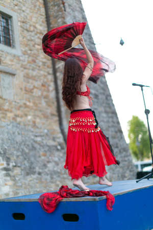 Montefiorino Modena, Italy: 2015 05 01 queen's day public event in the square with belly dancer and singer with fans and fabrics. High quality photoのeditorial素材
