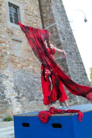 Montefiorino Modena, Italy: 2015 05 01 queen's day public event in the square with belly dancer and singer with fans and fabrics. High quality photoのeditorial素材