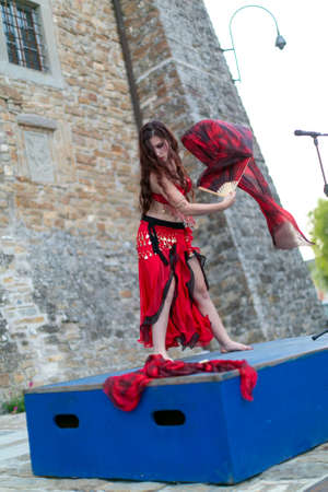Montefiorino Modena, Italy: 2015 05 01 queen's day public event in the square with belly dancer and singer with fans and fabrics. High quality photoのeditorial素材