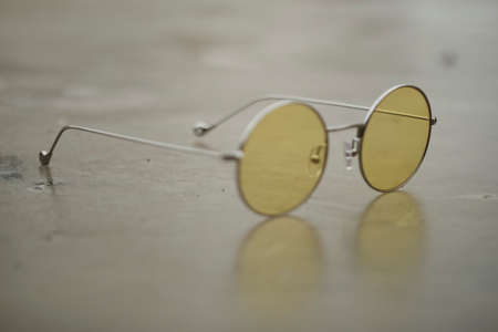 glasses with light frames and yellow and round lenses. High quality photoの写真素材