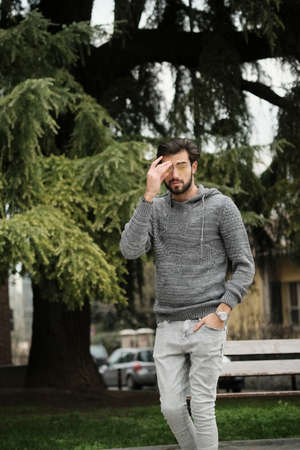handsome Italian dark-haired boy with sweatshirt strolling. High quality photoの写真素材