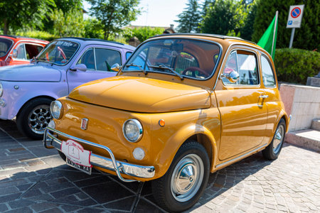 Bibbiano-Reggio Emilia Italy - 07 15 2015: Free rally of vintage cars in the town square yellow Fiat 500. High quality photoのeditorial素材