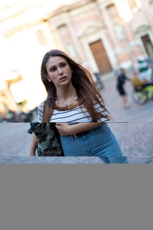 beautiful brunette Italian girl walks in the town. High quality photo