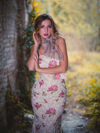 beautiful blonde girl in long flowered dress. High quality photo