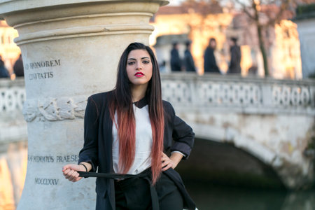 beautiful brunette girl standing in front of marble column. High quality photoの写真素材