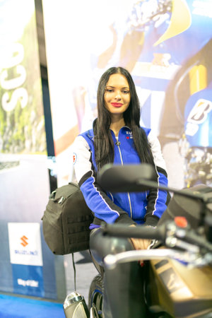 Milano, Italy - 2021 11 27: Eicma Milano Bike Expo beautiful black hair girl on bike. High-quality...