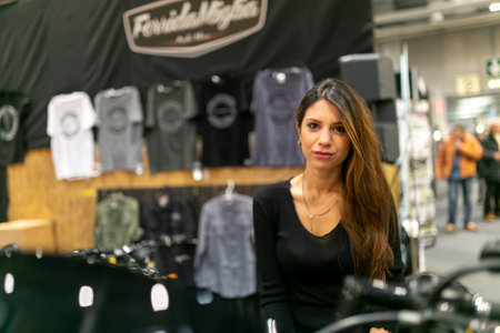 Milano, Italy - 2021 11 27: Eicma Milano Bike Expo beautiful black hair girl on bike. High-quality...