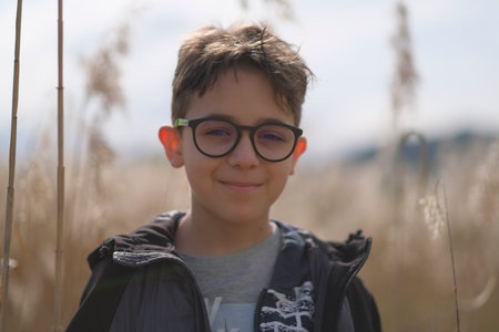 portrait of little boy with glasses in nature. High-quality photoの写真素材