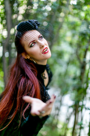 Lucca, Italy - 2018 10 31 : Lucca Comics free cosplay event around city dark vampire goth lady red hair. High-quality photoのeditorial素材