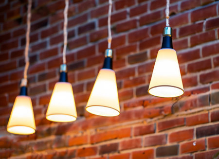 Many pendant lamps against red old brick wall. High-quality photoの写真素材