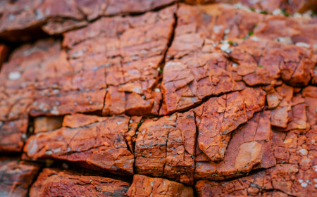Dark red orange brown rock texture with cracks. Close up. Rough mountain surface. Stone granite background for design. natures. High-quality photoの写真素材