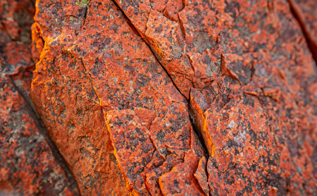 Dark red orange brown rock texture with cracks. Close up. Rough mountain surface. Stone granite...