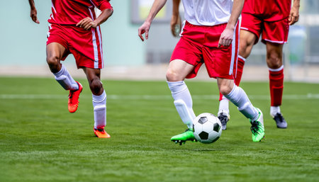 Close up of a soccer action scene with soccer players competing at the stadium. High-quality photoの写真素材