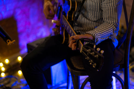 Guitarist hands play an electric guitar. High-quality photoの写真素材