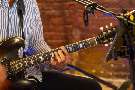 Guitarist hands play an electric guitar. High-quality photoの写真素材