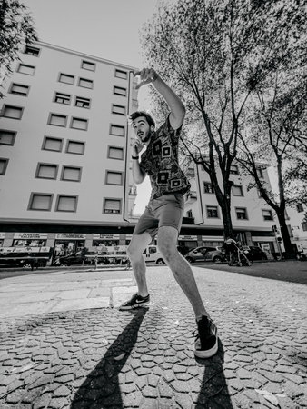 young boxer street fighter trains in the square between the buildings. High quality photoの写真素材