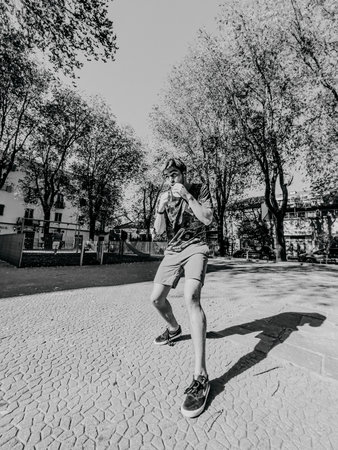 young boxer street fighter trains in the square between the buildings. High quality photoの写真素材