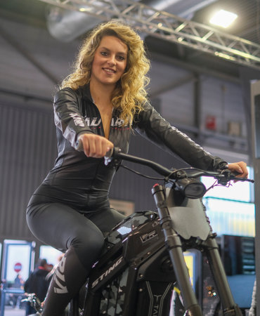 Verona, Italy - 2022 01 12 : MBE Verona Bike Expo Bike and Custom car exibituon - Beaufiful blonde girl on a bike. High quality photoのeditorial素材