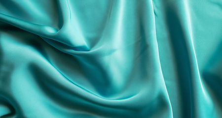 Closeup of rippled turquoise silk fabric as backgroundの素材
