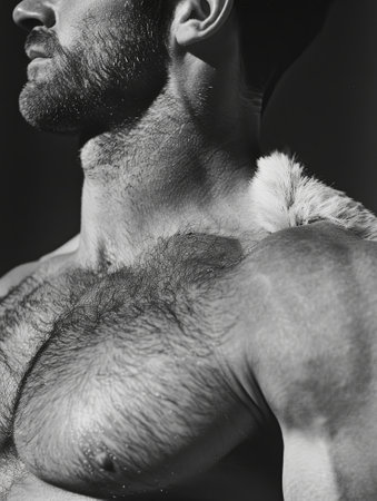 A black and white photo shows a man with a bearded jaw, furry chest, and a gray mustache. He exudes a commanding gesture with a dog breed snout visible in the backgroundの素材