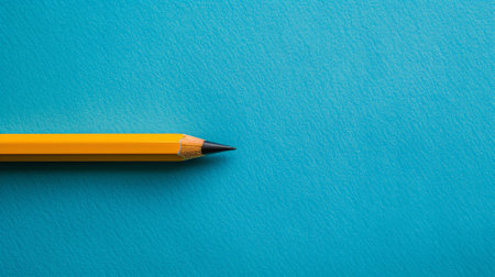 An electric blue writing implement, known as a pencil, rests on a vibrant blue surface among other office supplies like pens and stationeryの素材