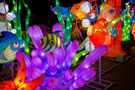 A vibrant array of colorful lanterns is beautifully illuminated during the night, creating a festive atmosphere that enchants everyoneの写真素材