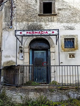 There is a very old and historic building featuring a sign prominently displayed above the door that reads pharmacyの写真素材