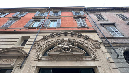 An impressive building featuring a large, intricately designed statue that prominently displays a...