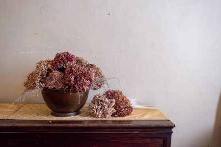 A beautiful vase that is filled with an assortment of dried flowers elegantly sits on a wellcrafted...