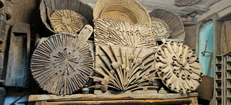 A collection of several wooden plates is carefully stacked on top of one another on a table, showing...